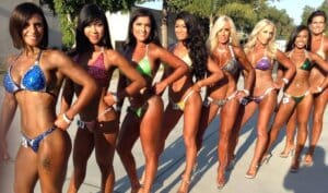Several Bikini competitors lined up at an event outside
